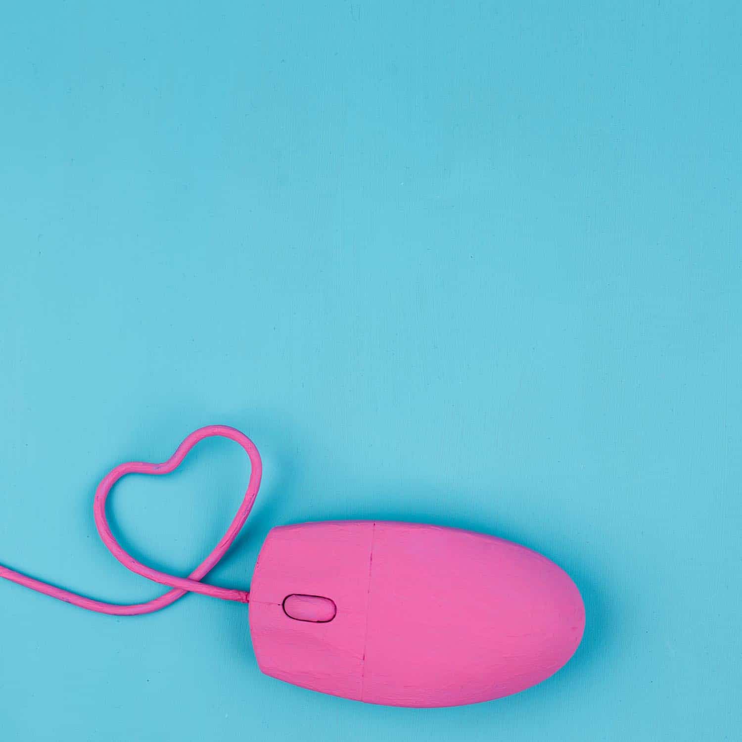 A pink mouse on a blue background