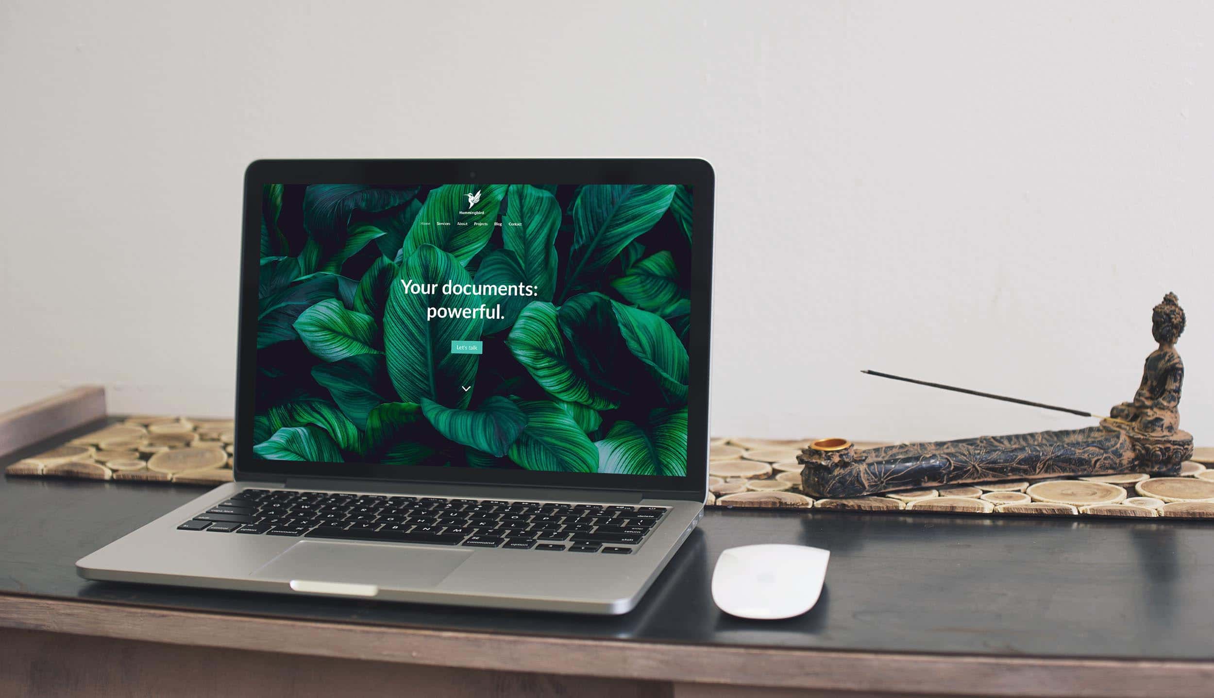 Laptop on desk displaying Hummingbird Writing website