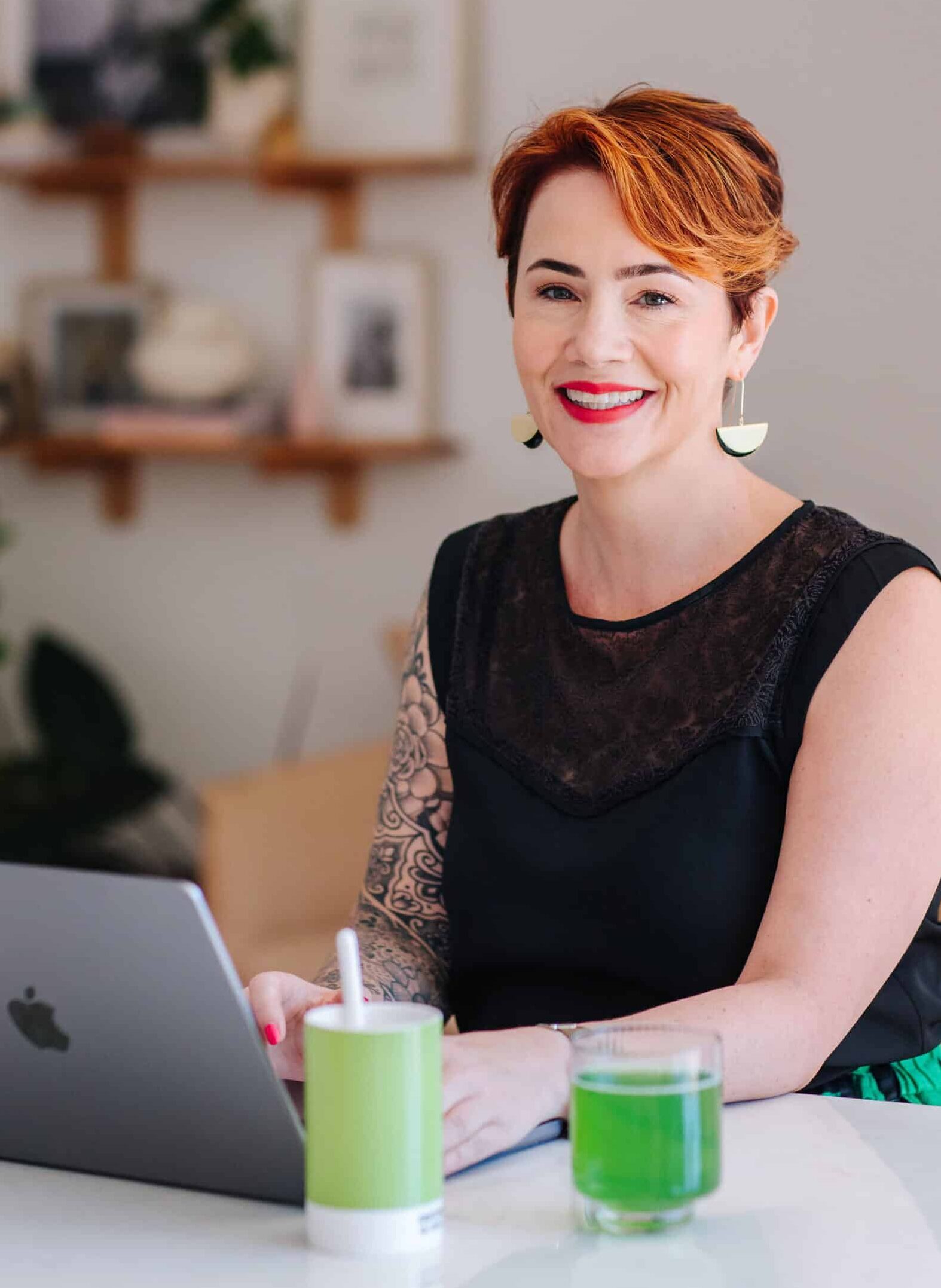 Kate Hall sitting at a bench with her computer smiling